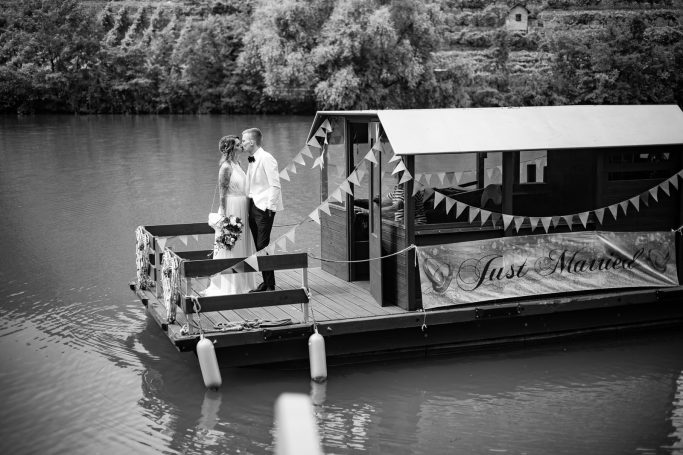 Hochzeit Heilbronn – Brautpaarshooting auf Boot auf dem Neckar Romantisches Brautpaarshooting auf einem Boot auf dem Neckar in Heilbronn – Brautpaar genießt Zweisamkeit auf dem Wasser, stilvolle Hochzeit